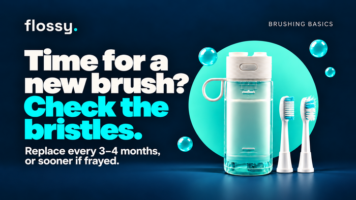 Flossy water flosser beside neat and frayed toothbrush heads on the established navy background.