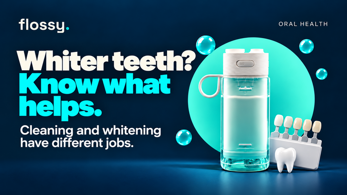 Flossy water flosser beside a small dental shade guide and tooth prop on the established navy background.